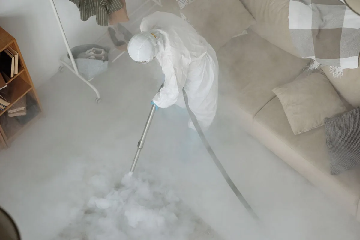 Biohazard cleanup technician in protective equipment, Junction City, KS